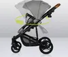 A side view of a gray baby stroller with yellow arrows indicating movement or adjustment. Anteprima dell’immagine prodotto