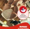 A baby wearing a diaper is shown upside down, with a marketing graphic overlay. Produktbild-Vorschau