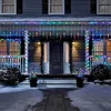 A house decorated with colorful icicle lights for Christmas. Produktbild-Vorschau