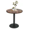A round bistro table with a wood-grain top and a black pedestal base, decorated with two small potted plants and a vase with greenery. Produktbild-Vorschau
