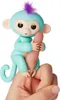 A turquoise finger monkey toy is gripping a human finger. Anteprima dell’immagine prodotto