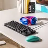 A gaming keyboard, mouse, and headphones are arranged on a white desk. Náhled obrázku produktu