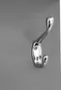 A close-up of a single silver coat hook mounted on a gray wall. Anteprima dell’immagine prodotto