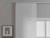 A close-up view of a sliding panel curtain covering a window, with a framed piece of art on the wall to the left. Produktbild-Vorschau