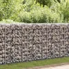 A gabion wall filled with stones, with green foliage in the background and grass in the foreground. Podgląd zdjęcia produktu