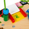 A close-up view of a colorful wooden toy with various interactive elements. Podgląd zdjęcia produktu
