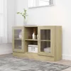 A wooden sideboard with glass doors is shown in a room with a rug and a window. Produktbild-Vorschau