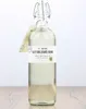 A bottle of alcohol on a wooden surface against a white background. Produktbild-Vorschau