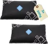 Two black dehumidifier bags with a geometric pattern and a blue diamond in the center, placed on a white background. A tan tag with text is attached to the top bag. Produktbild-Vorschau