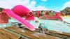 A cartoon-like racing game scene with toy cars on a wooden bridge over water, with a giant pink octopus in the background. Produktbild-Vorschau