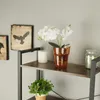 A shelf with decorative items including a vase with flowers, a candle, and a jar. Náhled obrázku produktu