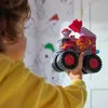 A child holding a toy fire truck with a character inside. Produktbild-Vorschau
