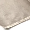 A close-up, angled view of a roll of beige linen fabric with a raw edge. Produktbild-Vorschau