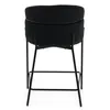 A black upholstered stool with a metal frame, shown from the back. Produktbild-Vorschau