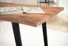 A close-up view of a wooden desk with black metal legs, showing a book open on the surface. Voir les images du produit