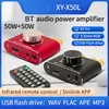 Two audio amplifiers, one red and one black, are shown with a remote control and feature callouts. Produktbild-Vorschau
