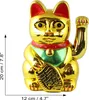 A golden Maneki-neko cat figurine with a red collar and green bib, holding a golden fish. Produktbild-Vorschau