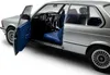 A close-up, studio shot of a silver BMW 323I E21 model car with the driver's side door open, revealing the blue interior. Anteprima dell’immagine prodotto