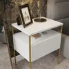 A white and gold nightstand is shown in a bedroom setting. Produktbild-Vorschau
