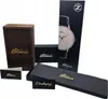 Various packaging boxes for a watch, including a wooden box and a long black box with a watch illustration. Produktbild-Vorschau