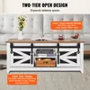 A farmhouse-style coffee table with sliding barn doors and open shelving, placed in a living room setting. Voir les images du produit