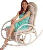 A woman is sitting in a rocking chair. Produktbild-Vorschau