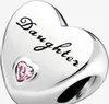 A close-up studio shot of a silver heart-shaped charm with the word "Daughter" engraved on it and a small pink heart-shaped gemstone. Podgląd zdjęcia produktu