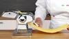 A person is using a pasta maker to create a sheet of pasta. Produktbild-Vorschau