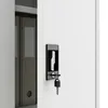 A close-up view of a metal cabinet lock and key, with a file folder visible inside the cabinet. Podgląd zdjęcia produktu