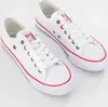 A pair of white canvas sneakers with red and blue accents. Produktbild-Vorschau
