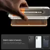 A hand is shown using an installation jig to apply a screen protector to a phone. Below, three phones are displayed in different colors. Náhľad obrázku produktu