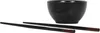 A black ceramic bowl and two black chopsticks with brown tips are arranged on a white background. Náhled obrázku produktu