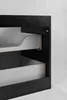 A close-up view of the side of a black cabinet with two open drawers. Náhled obrázku produktu