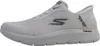 A side view of a white Skechers Go Walk slip-on sneaker. Voir les images du produit