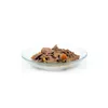 A close-up of wet dog food in a clear bowl. Produktbild-Vorschau