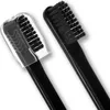 Two black toothbrushes, one with a clear protective cap, are shown against a white background. Anteprima dell’immagine prodotto