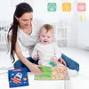 A mother and baby are sitting on the floor, looking at a soft fabric book. Anteprima dell’immagine prodotto