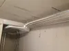 Insulated pipes installed on a concrete ceiling and wall. Produktbild-Vorschau