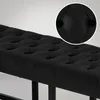 Close-up view of a black tufted bench with a detailed inset. Náhled obrázku produktu