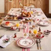 A festive Christmas breakfast table setting with various food items and decorative elements. Náhled obrázku produktu