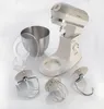 A kitchen mixer and its accessories are arranged on a white surface. Náhled obrázku produktu