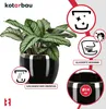 A black ceramic plant pot with a silver rim, featuring a plant inside. Informational icons and text are present on the right side. Náhľad obrázku produktu