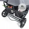 Close-up view of the storage baskets of a double stroller, filled with groceries. Produktbild-Vorschau