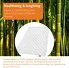 A close-up of a white quilted blanket with a bamboo forest in the background. Produktbild-Vorschau