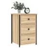 A wooden nightstand with three drawers and black accents, decorated with a vase of flowers and an alarm clock. Produktbild-Vorschau