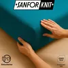 Hands are shown adjusting a teal-colored fitted sheet, with a logo and certifications visible. Produktbild-Vorschau