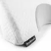 A close-up of a white quilted pillow with a gray curved section and a black tag with white text. Náhľad obrázku produktu