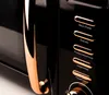 Close-up view of a black microwave with copper accents. Anteprima dell’immagine prodotto