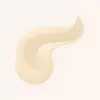 A swatch of light cream-colored serum or foundation is shown on a plain background. Voir les images du produit