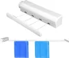 A retractable clothesline mounted on a wall, with two blue towels hanging from it. Náhľad obrázku produktu